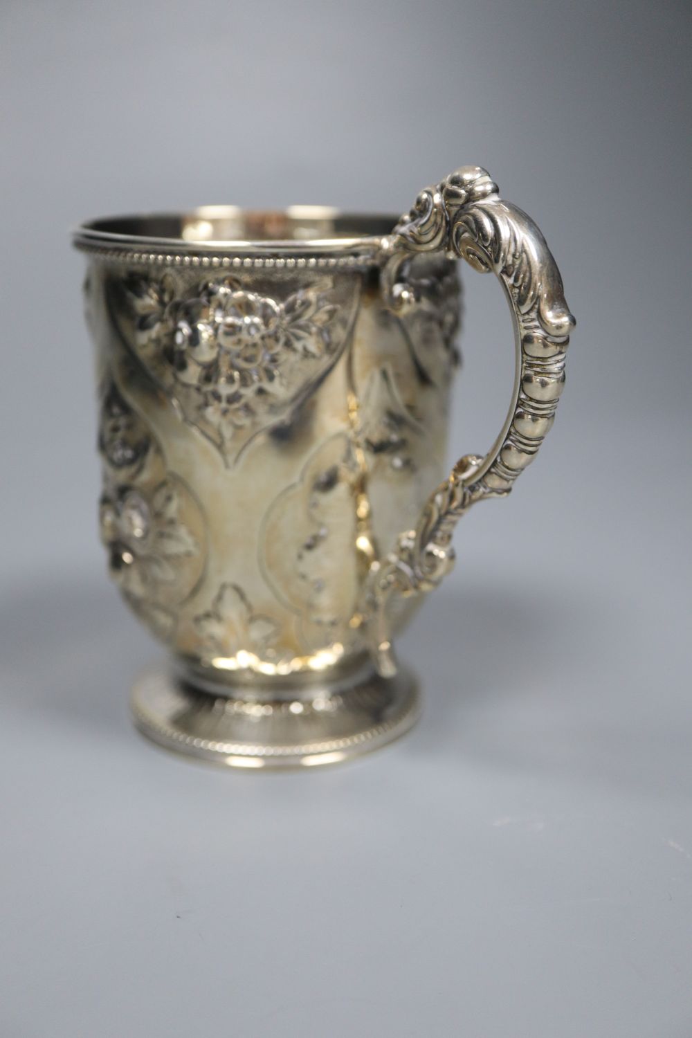 A Victorian embossed silver christening mug, George Adams, London, 1875, 10.7cm, 142 grams.